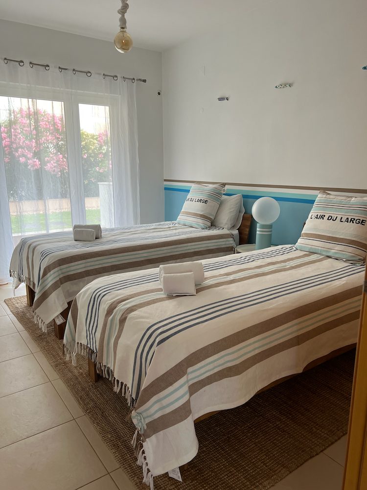 Twin bedroom at Casa Solaris with two single beds and striped throws