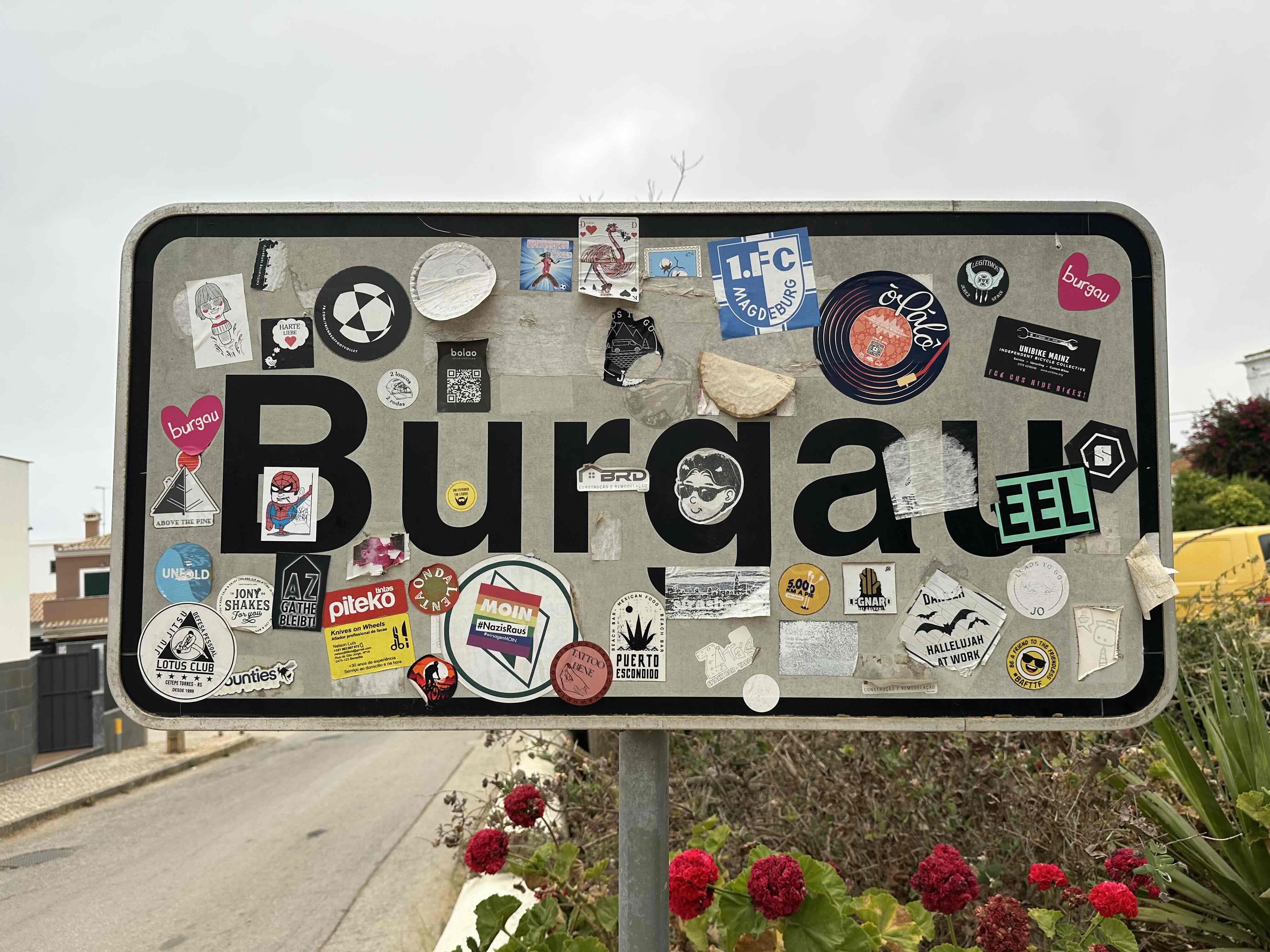The sticker-covered Burgau village sign, a local landmark