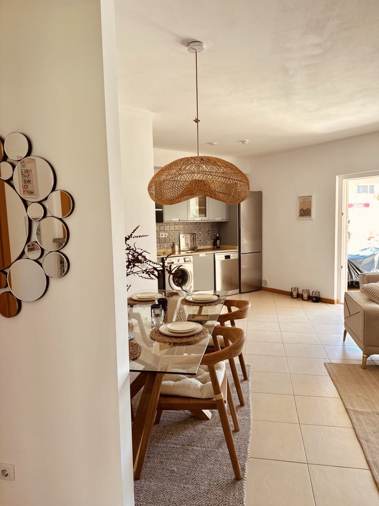 Open kitchen and dining area with woven pendant light at Casa Solaris