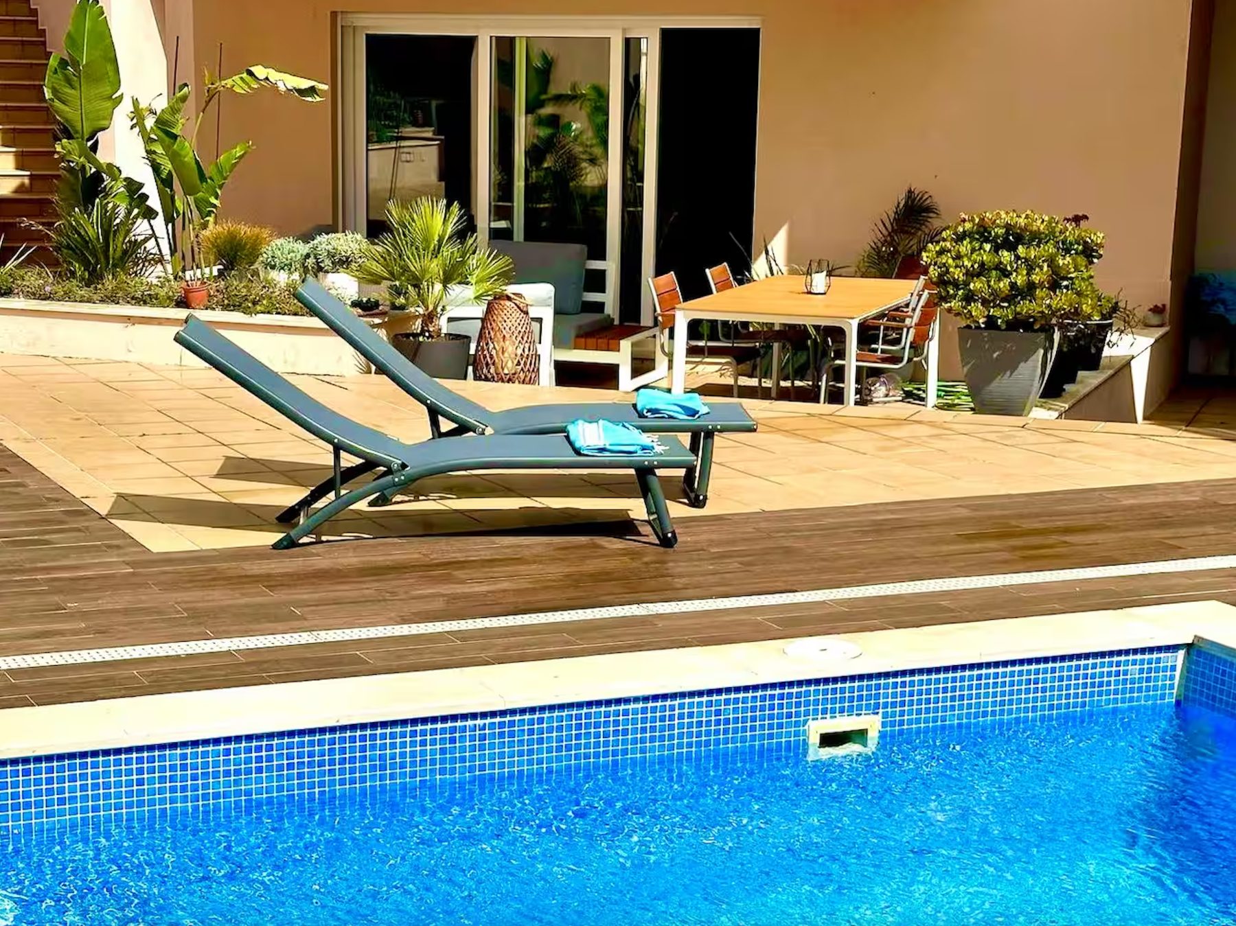 Sun loungers on the deck beside the blue pool at Casa Solaris in Burgau
